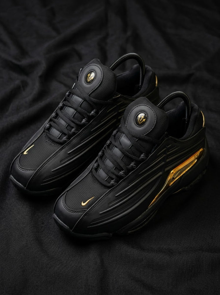 Nike Hot Step 2 x NOCTA Negro / Dorado Cromado