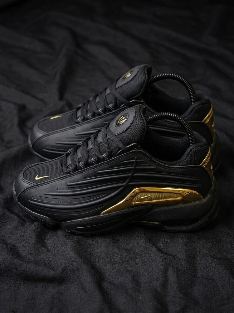 Nike Hot Step 2 x NOCTA Negro / Dorado Cromado